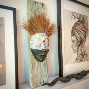 Raku mask on driftwood